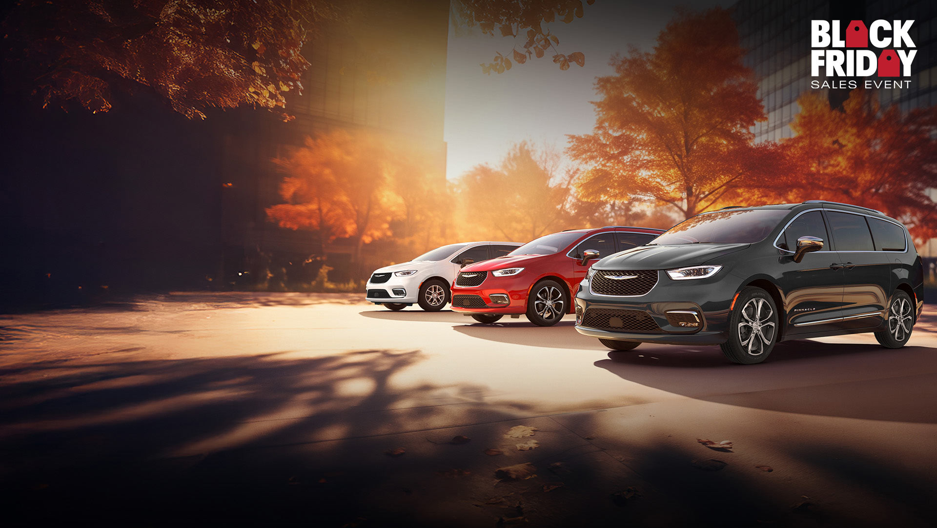 Tres modelos de la minivan Chrysler 2026 estacionados en una playa junto al mar. De izquierda a derecha: Chrysler Voyager blanca, Pacifica Pinnacle Plug-in Hybrid azul y Pacifica Pinnacle roja. Evento de ventas Black Friday.