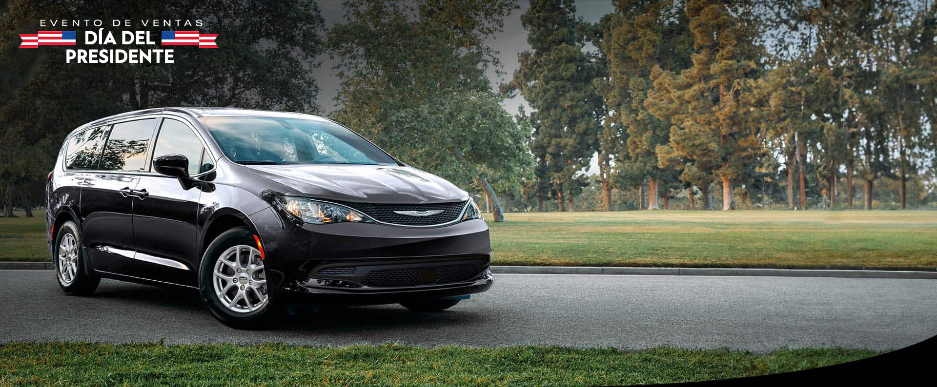 Vista frontal del lado del pasajero del Chrysler Voyager LX 2026 en el estacionamiento de un parque. Evento de ventas Día del Presidente.